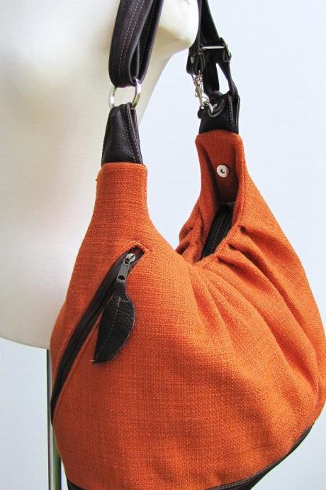 Extra large orange canvas convertible backpack, messenger, tote, diaper bag with leather straps, base, and zipper top closure